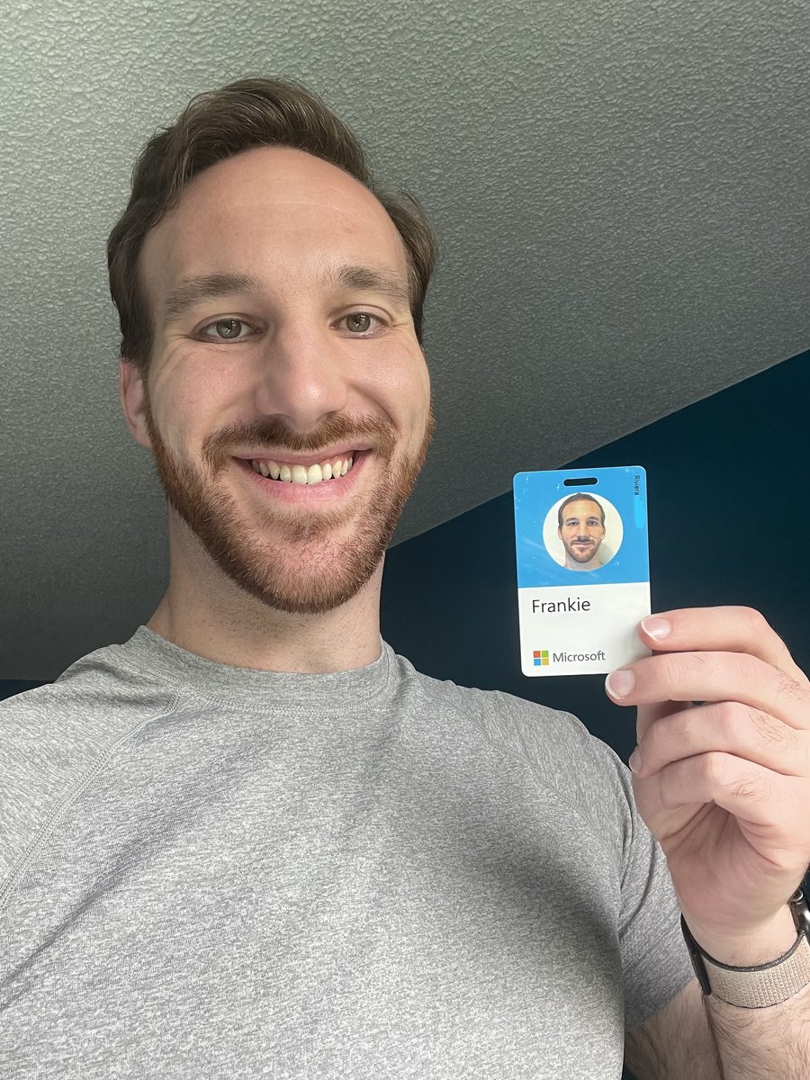 Frankie Riviera holding his Microsoft employee badge